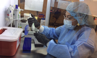 DNA Analyst trainee processes samples